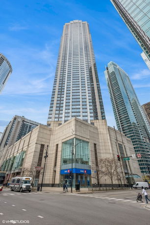 Front view of a tall skyscraper with a modern glass and concrete facade.