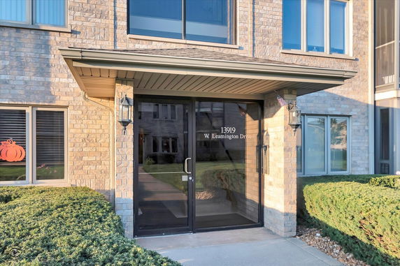 Entrance view of a building with brick exterior and glass door.