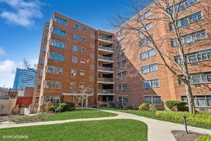 Front view of a multi-story brick apartment building.