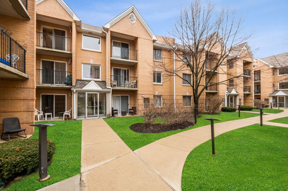 Front view of a multi-story apartment building with balconies.