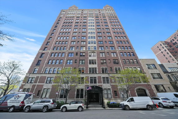 Front view of a tall multi-story brick building.