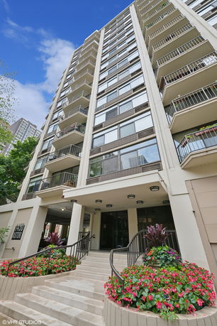 Front view of a multi-story residential building with balconies.