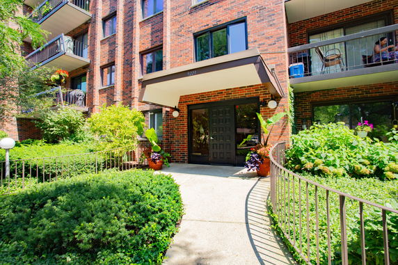 Front view of a multi-story brick building with balconies.