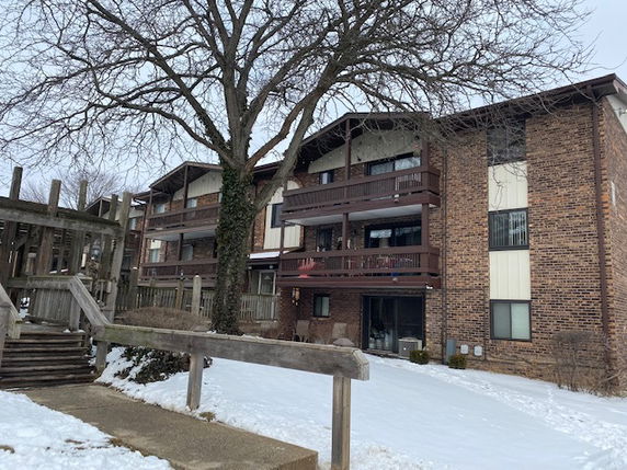 Front view of a multi-story apartment building with balconies.