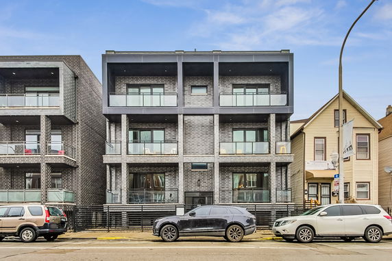 Front view of a multi-story building with balconies.