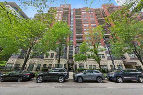 Front view of a multi-story residential building with balconies.