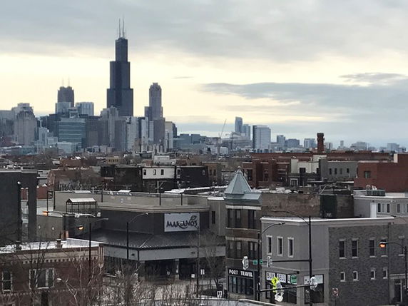 View of urban buildings with a skyline in the background.