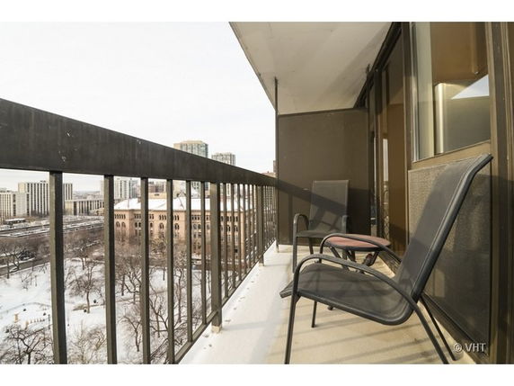 Balcony view overlooking a snowy cityscape.