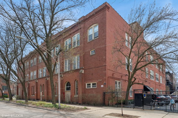 Front view of a large, multi-story brick building.