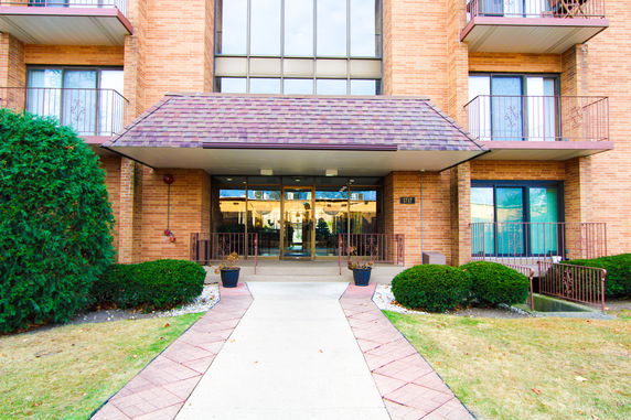 Front view of a multi-story brick building with a covered entrance.