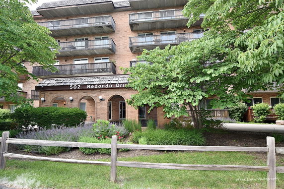 Front view of a multi-story building with balconies.
