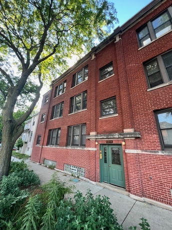 Front view of a multi-story brick building.