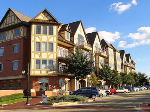 Front view of a multi-story apartment building with Tudor-style architecture.