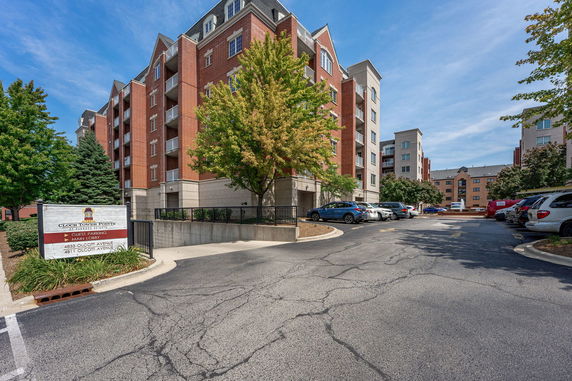 Front view of a multi-story residential building with brick facade and balconies.