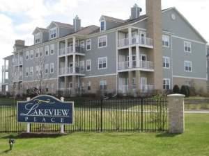 Front view of a multi-story apartment building with balconies.