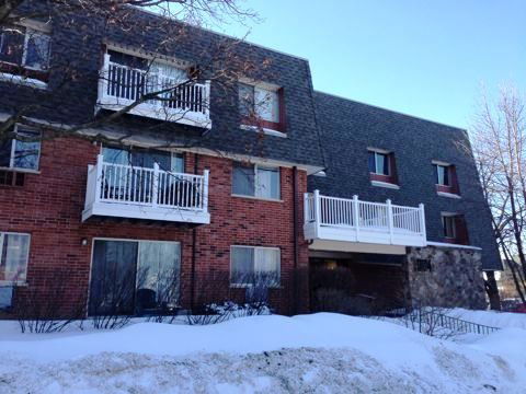 Front view of a multi-story apartment building with balconies.