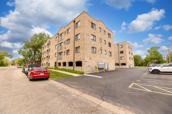 Front view of a multi-story building with brick exterior.