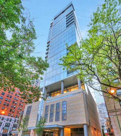 Front view of a modern multi-story building with glass facade.