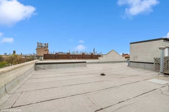 Rooftop area with a clear view of an urban skyline in the background.