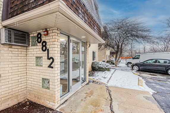 Front view of a building entrance with number 8812 on the wall.