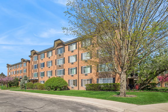 Front view of a multi-story brick apartment building.