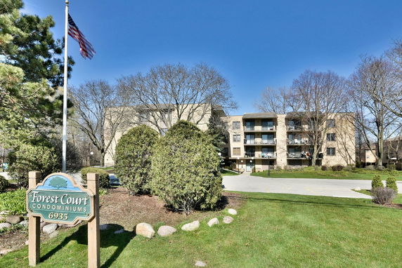 Front view of a multi-story condominium building with balconies.
