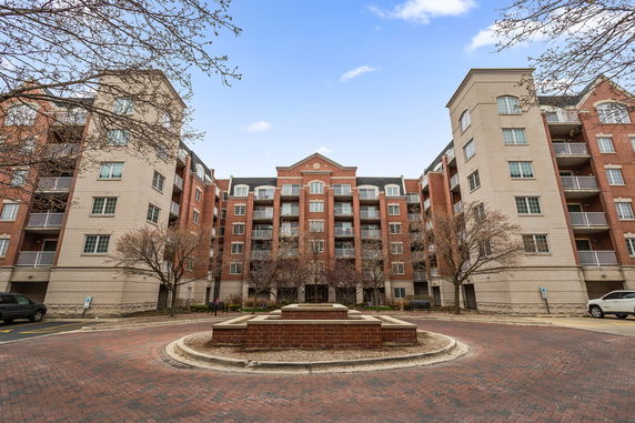Front view of a multi-story apartment building with balconies.
