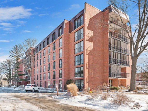 Front view of a multi-story brick apartment building.
