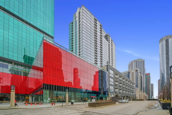 Front view of a modern multi-story building with glass facade.