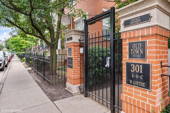 Front view of a brick residential building with gated entrance.