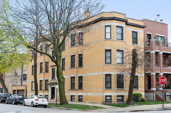 Front view of a multi-story brick apartment building.