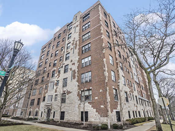 Front view of a multi-story brick apartment building.