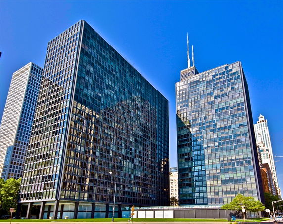 Front view of tall office buildings with glass exteriors.