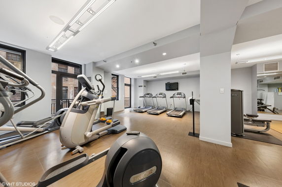 Indoor gym with exercise equipment including treadmills and ellipticals.