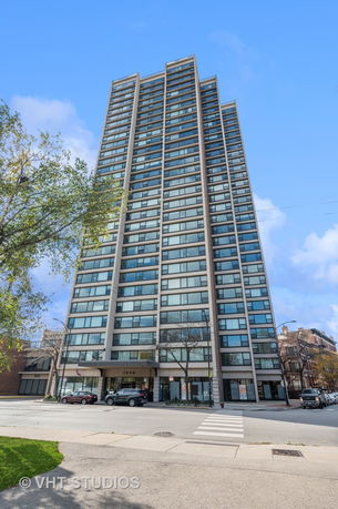 Front view of a tall high-rise building with multiple windows.