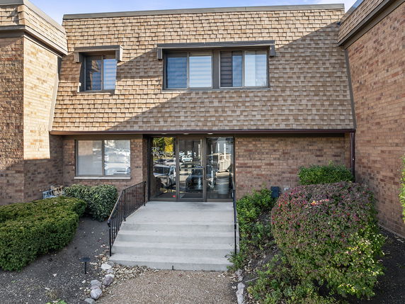 Front view of a two-story brick building with a central entrance.