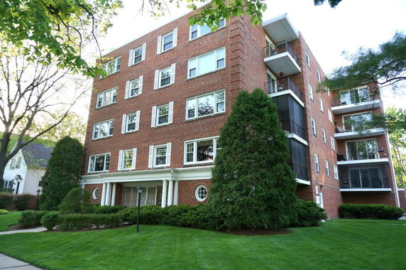 Front view of a multi-story brick apartment building.