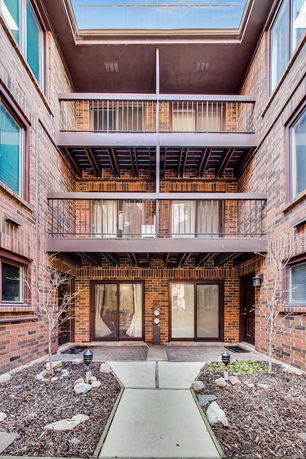 Exterior view of a multi-story brick building with balconies.