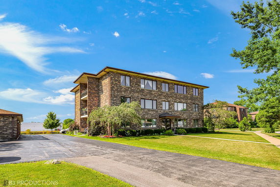 Front view of a multi-story brick apartment building.