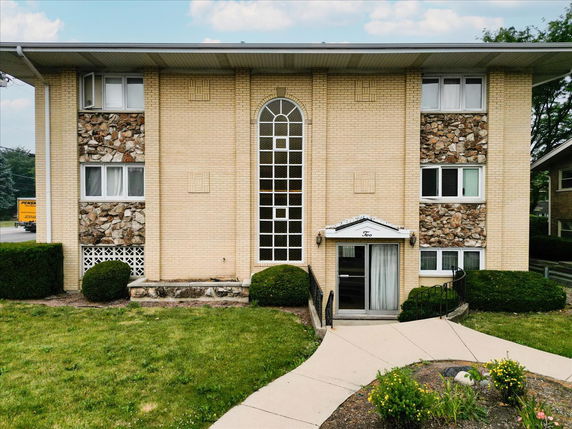 Front view of a two-story building with stone accents.
