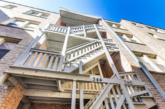 View of a multi-story brick building with an external staircase.