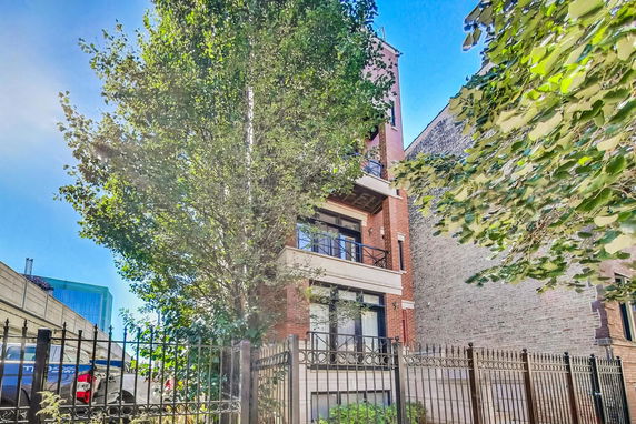 Front view of a multi-story brick building with balconies.