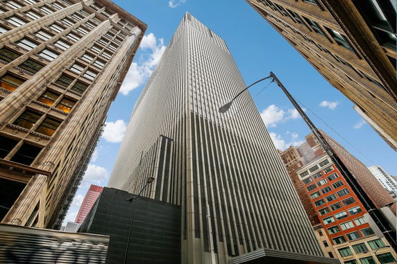 Front view of a tall building with a modern facade.