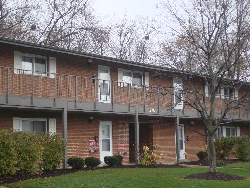 Front view of a two-story brick apartment building.