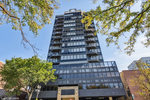 Front view of a tall modern building with balconies.