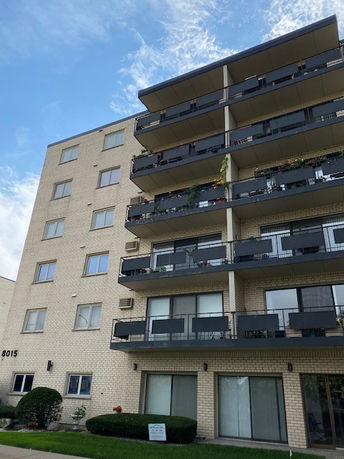 Front view of a multi-story building with balconies.