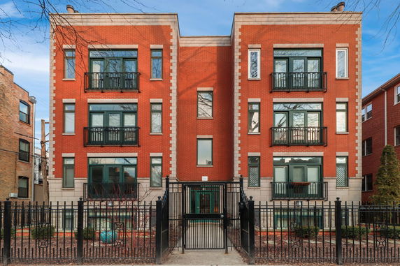 Front view of a three-story brick apartment building.
