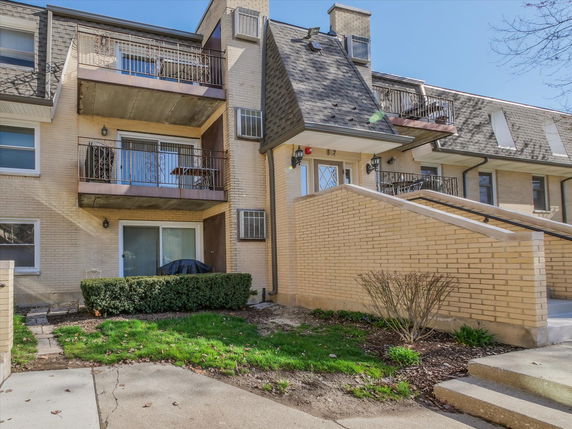 Front view of a multi-story residential building with balconies.