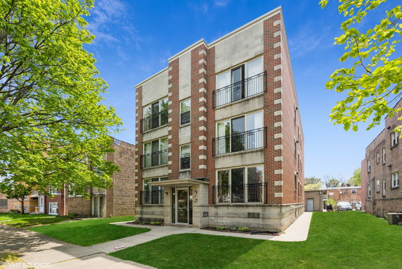 Front view of a three-story brick apartment building.