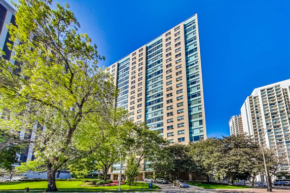 Front view of a tall residential building with numerous windows.